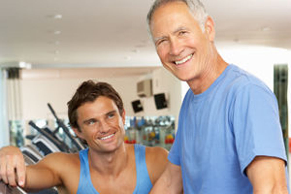 image of two men smiling whilst in a gym