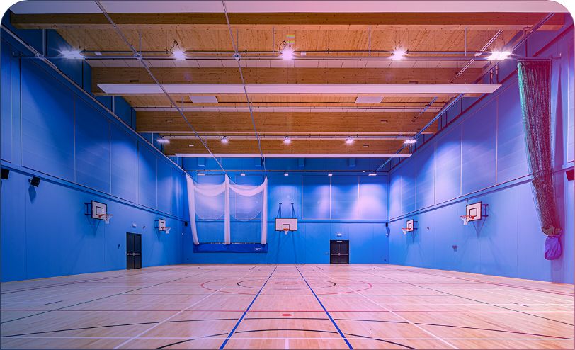 Empty sports hall with basketball hoops
