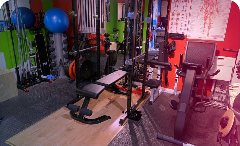 small gym room with varied exercise equipment