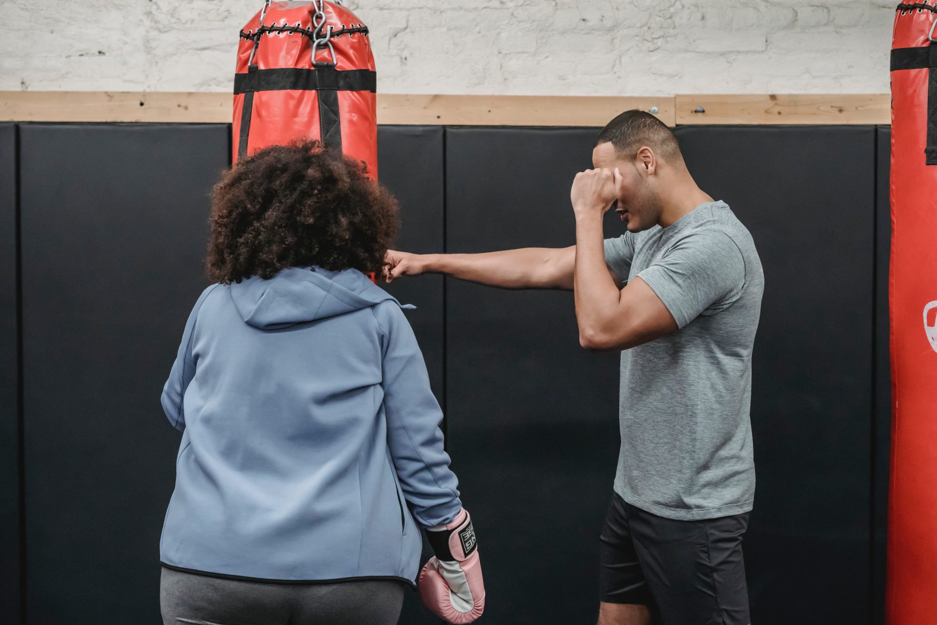 Men training women for boxing